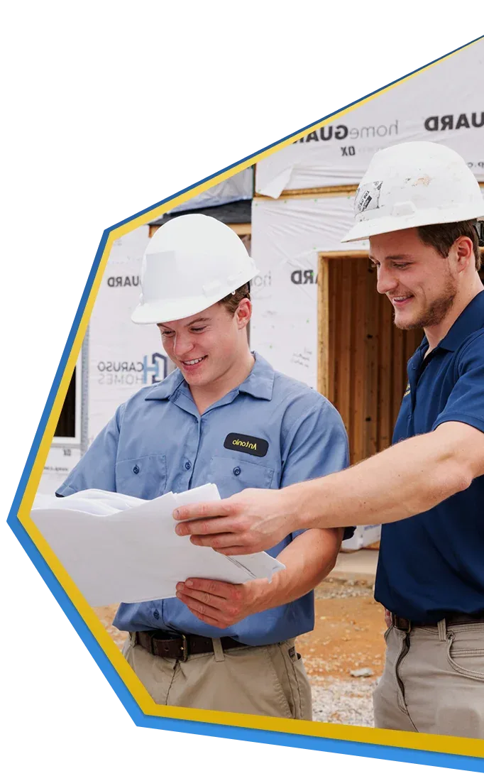 All American Heating, Air & Plumbing technicians reviewing plans at a new-construction job site