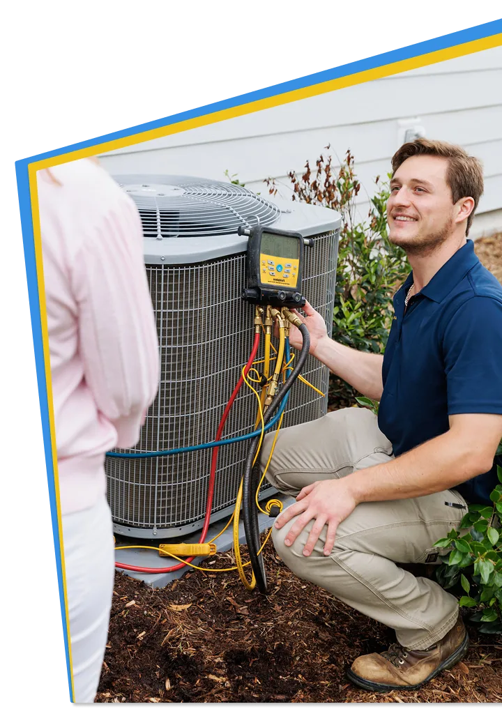 All American Heating, Air & Plumbing technician servicing an outdoor AC unit while talking with a customer