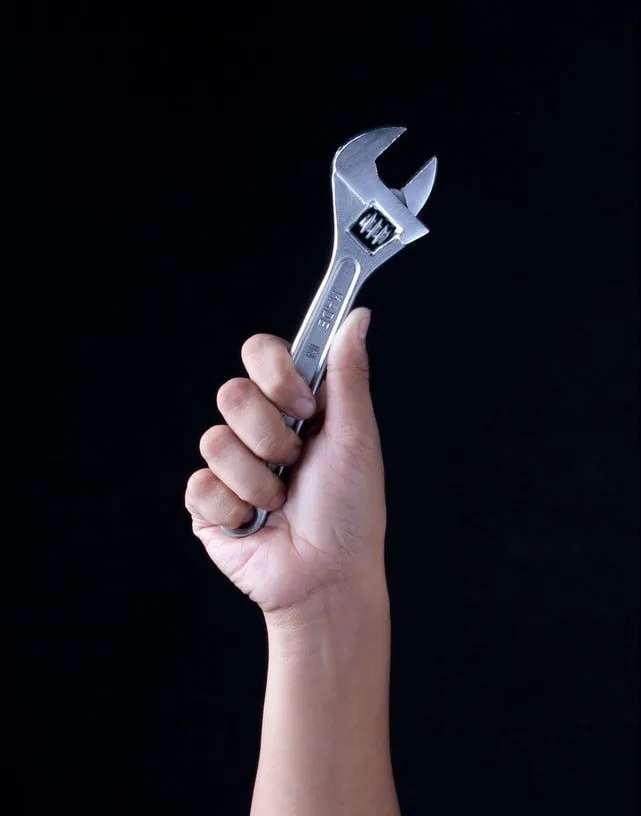 Person adjusting a home thermostat