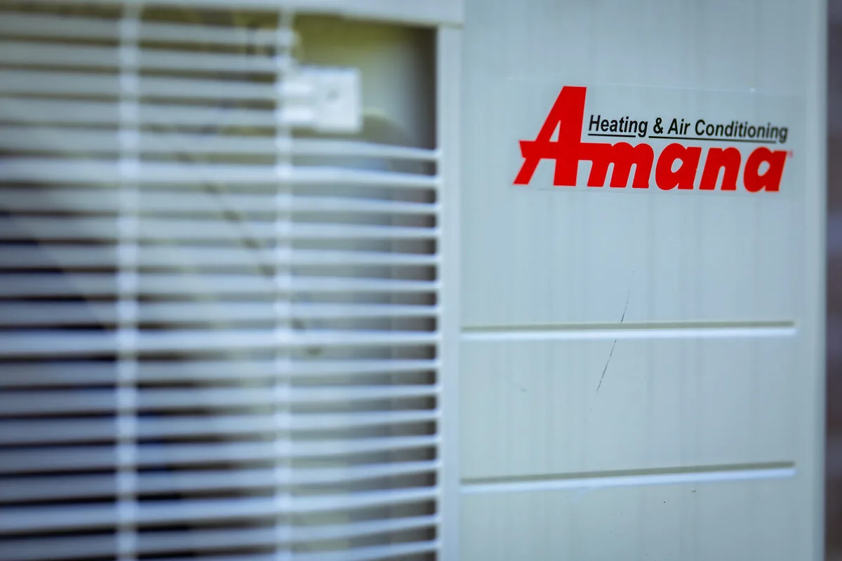 Close-up of an Amana logo decal on HVAC equipment
