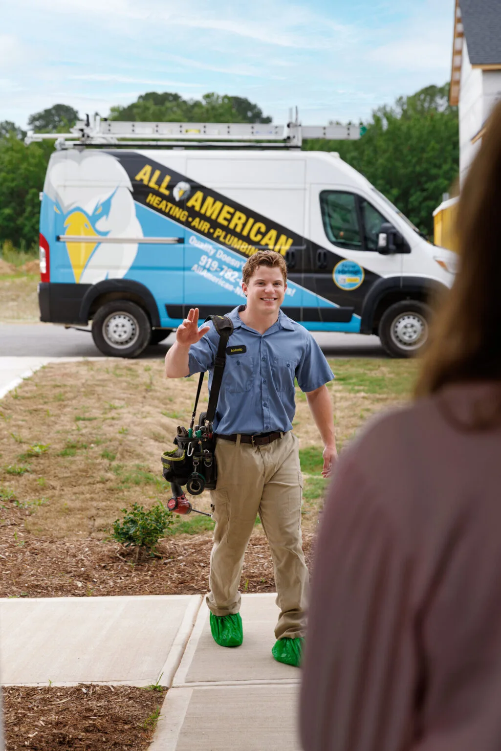 Technician greeting a customer at their doorstep